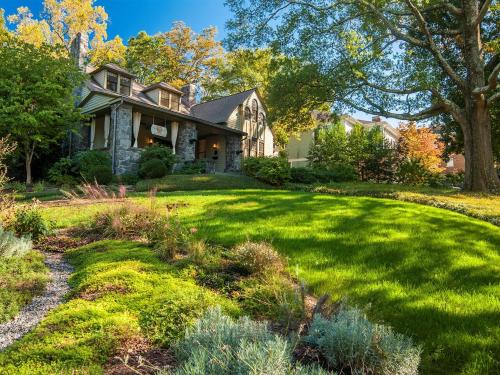green grass lawn and landscaping with Stonehurst Place in background