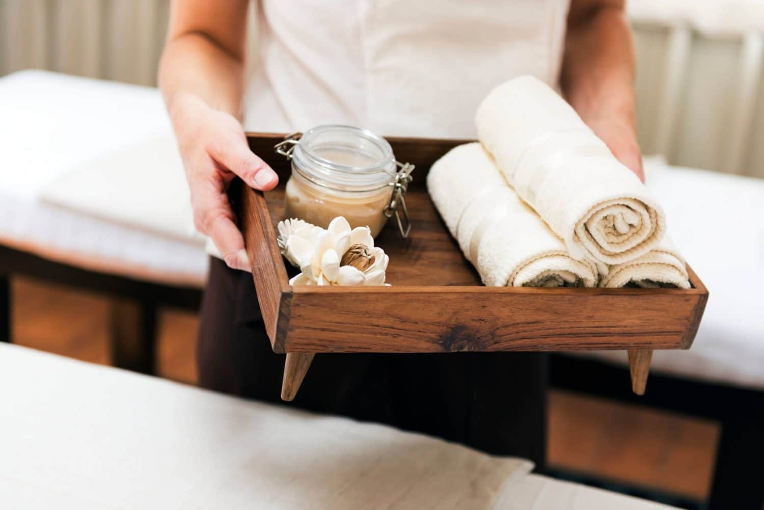 Someone holding a tray of towels at a spa