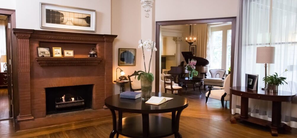 Stonehurst Place Foyer wooden mantle and fireplace wooden table in center