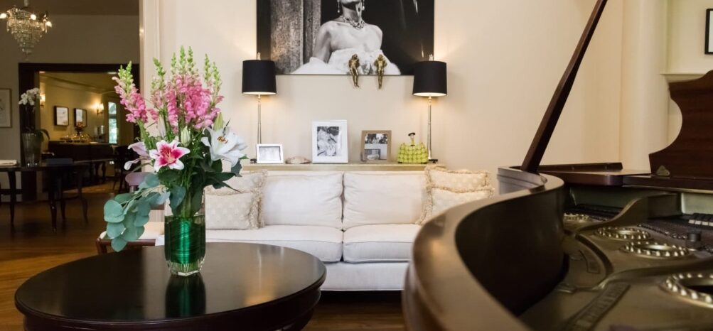 Artwork and a grand piano in the Music Room at Stonehurst Place