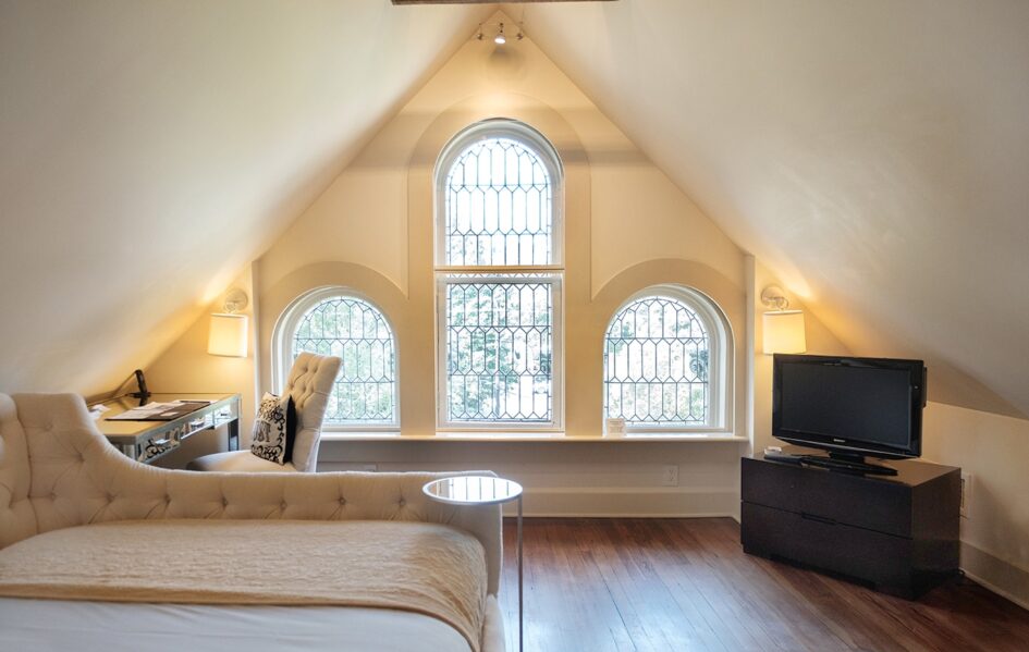 Eaves Room-Hero (1) Eaves Room with large arched windows in Stonehurst Place