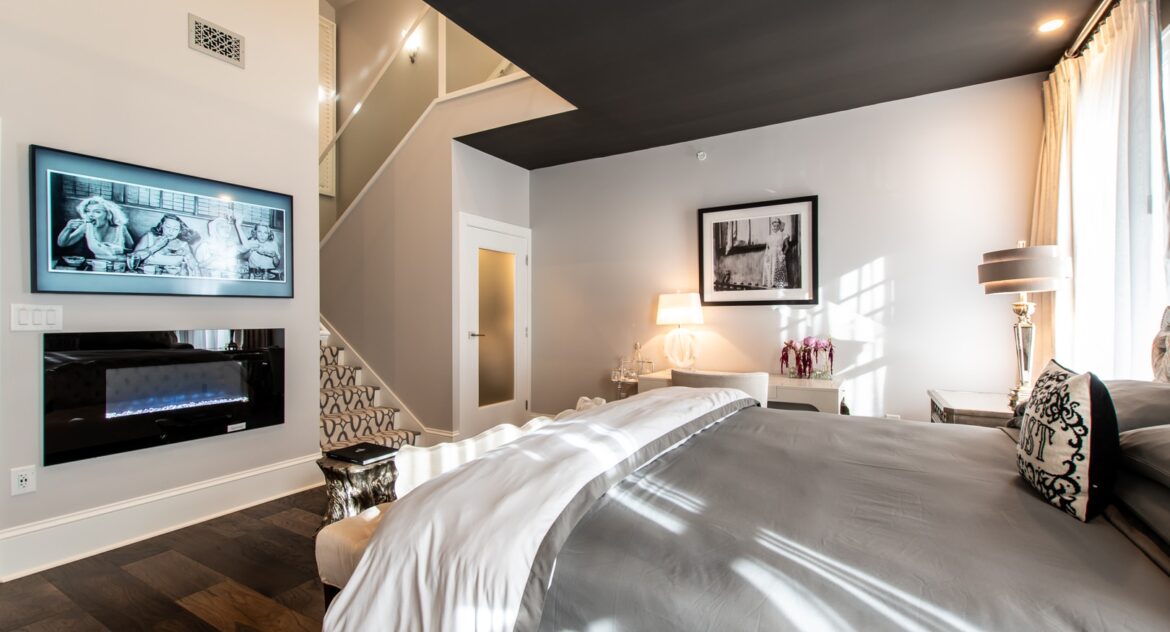 Fowler suite with a fireplace and a framed black and white picture of women eating above