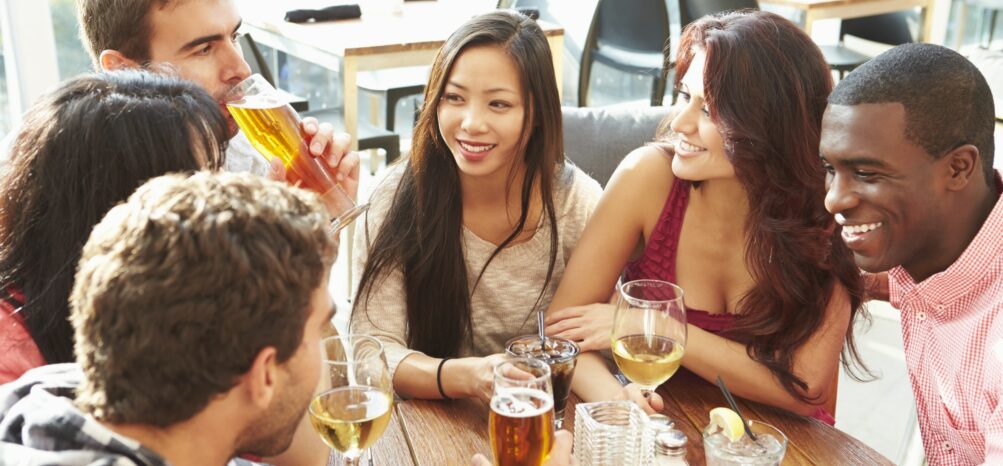 Group Of Friends Enjoying Drink At Outdoor Rooftop Bar Group Of Friends Enjoying Drink At Outdoor Rooftop Bar