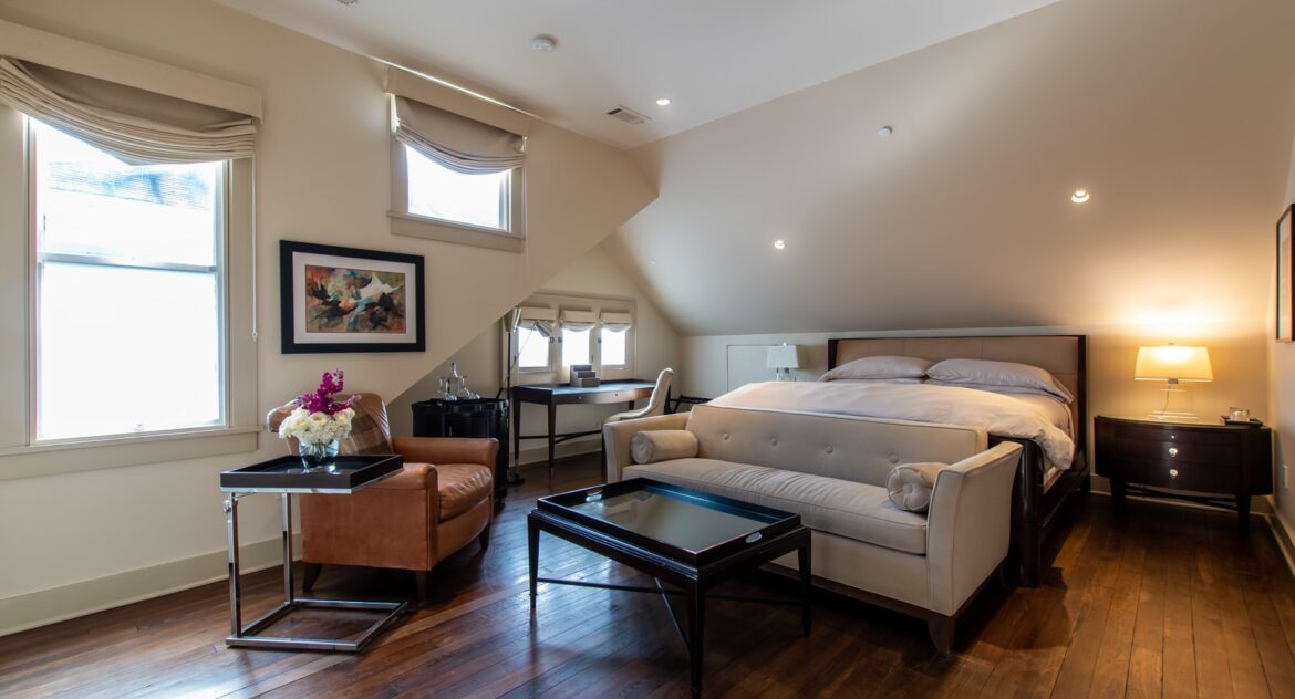 The Gables room sitting area with mirrored coffee table and a lounge sofa