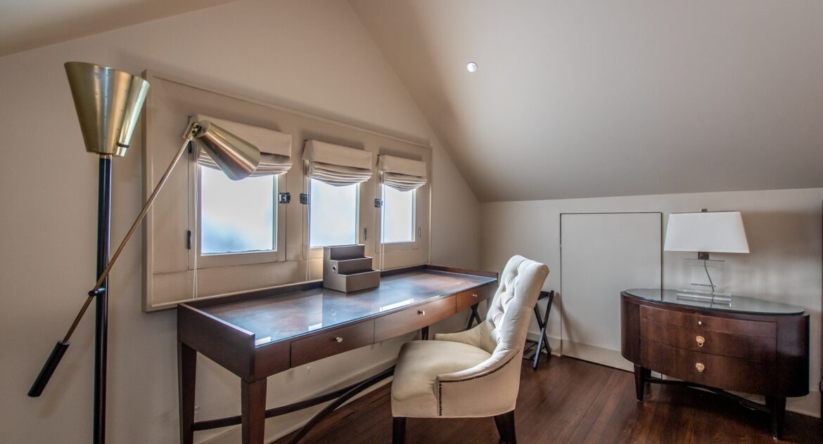 The Gables room arm chair and desk with a floor lamp