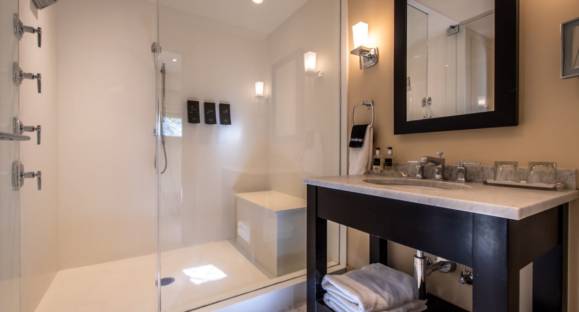The Gables room bathroom vanity area with a rectangle mirror on top