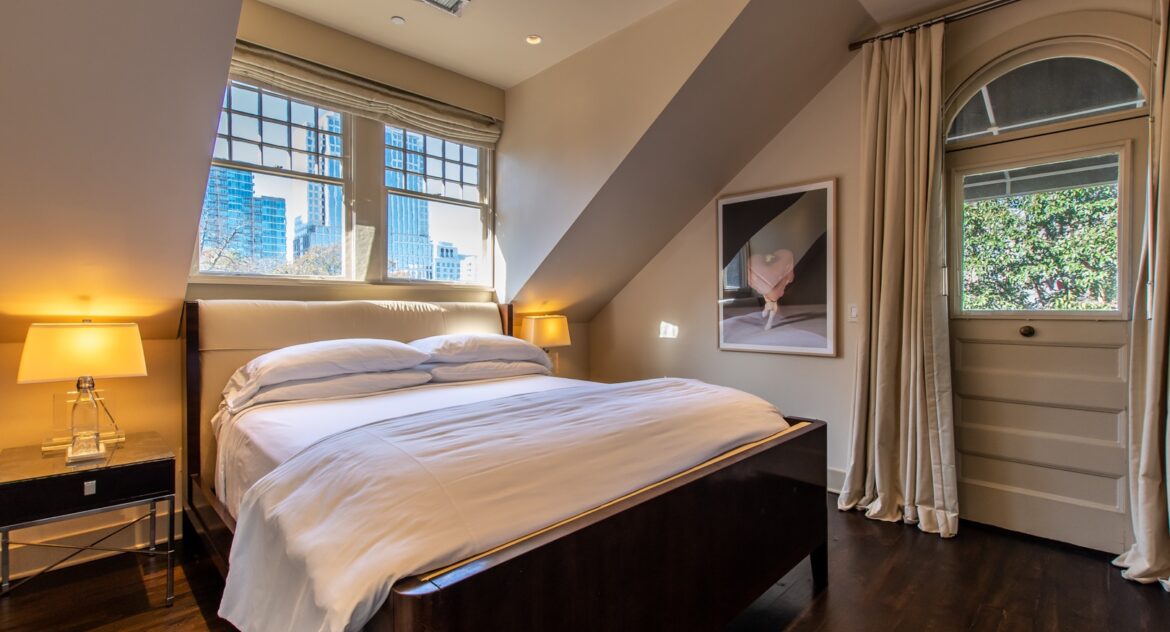 Master Suite bed with view of Atlanta through the windows