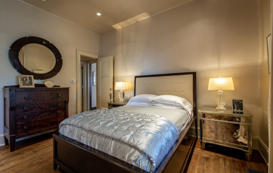 The PiedmontStonehurst Pl-44 The Piedmont room with a four drawer wood dresser with circular mirror above