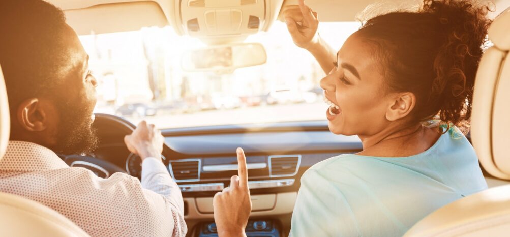 A man and woman in a car during a Charlotte to Atlanta road trip