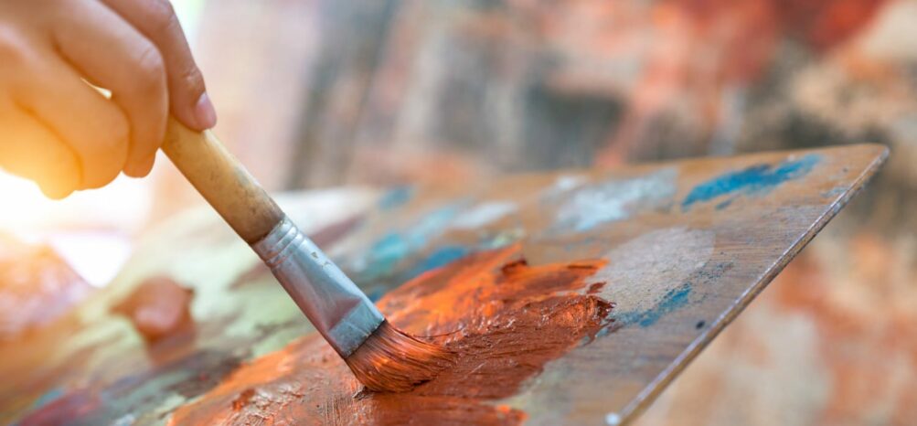 A close-up view of someone painting at the Fall Festival on Ponce