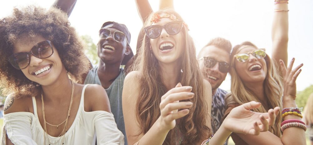 A group of people cheering at the Imagine Music Festival in Atlanta