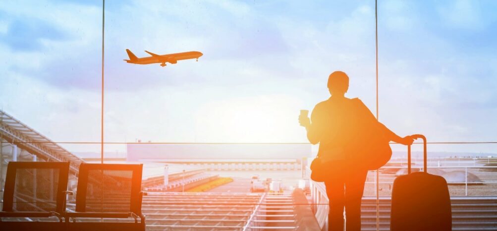 A woman looking at a plane, about to board a New York to Atlanta flight