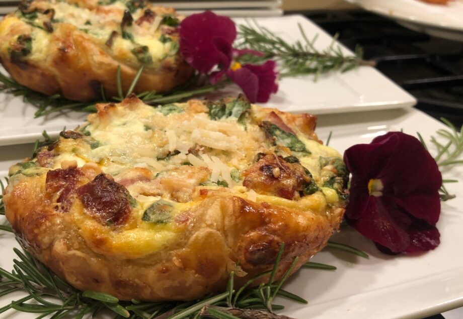 pastry with meat with rosemary and purple flower garnish on white dish at Stonehurst Place