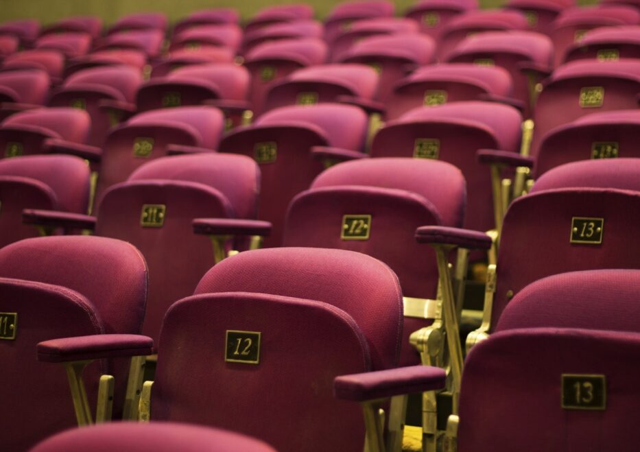 red theater seats with gold numbers and gold accents